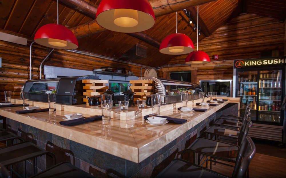 The sushi bar with red pendant lights at King Sushi.