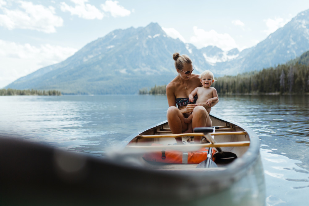 A happy mother and baby canoes in Grand Teton National Park.