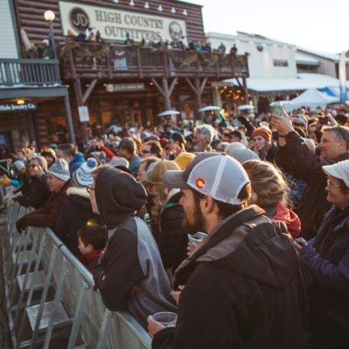 A crowd enjoying live music at the Rendezvous fest on the Jackson Hole town square.