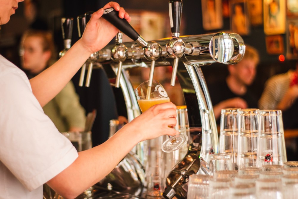 A bartender pours a beer at Snake River Brewing.