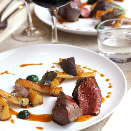 A rare piece of steak elegantly plated at Snake River Grill.