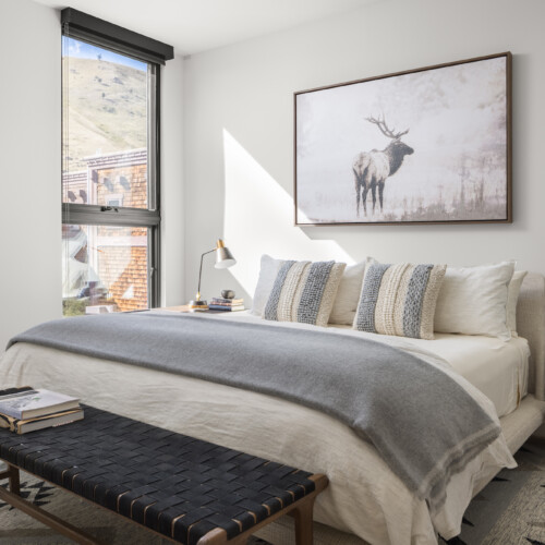 A well-lit bedroom with elegant interior design.